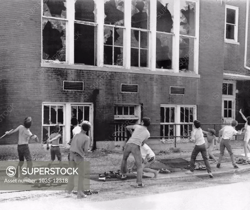 East Alton, Illinois:  August 13, 1971 Ten school children caught in the act of breaking winodws at their school, except this time it was OK. The school is to be torn down and they had permission to do so.