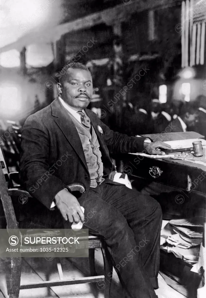 United Sates: August 5, !924. Publisher and orator Marcus Garvey seated at his desk.