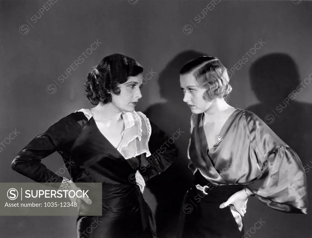 Hollywood, California:  c. 1930. Two women staring angrily at each other.