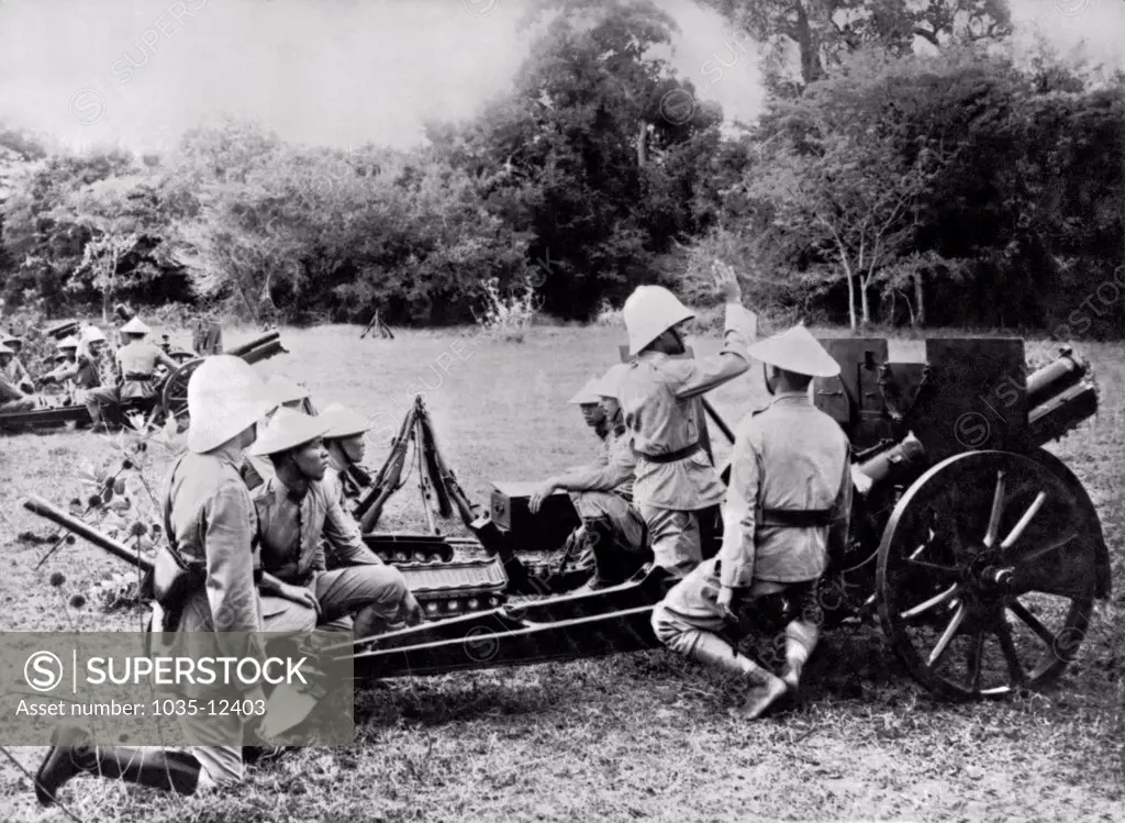 Indochina:  c. 1910. French cannoniers instructing the Indochinese in the use of modern armaments.