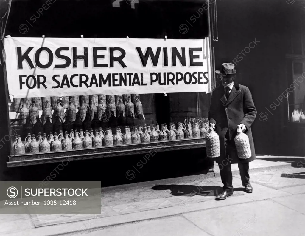 New York, New York:  c. 1930 A Jewish man buying kosher wine for sacramental purposes.