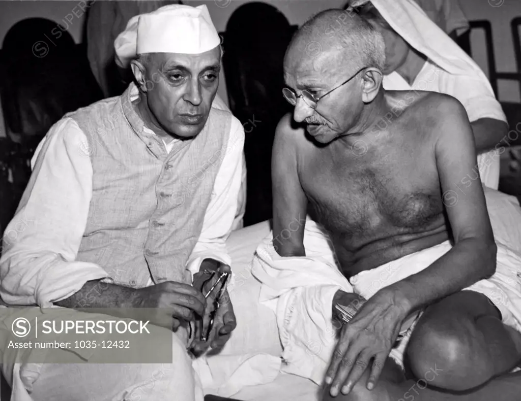 Bombay, India:  July 15, 1946 jawaharlal Nehru, the newly elected President of the All India Congress, talking with Mahatma Gandhi, Indian political strong man, at a meeting of the Congress.