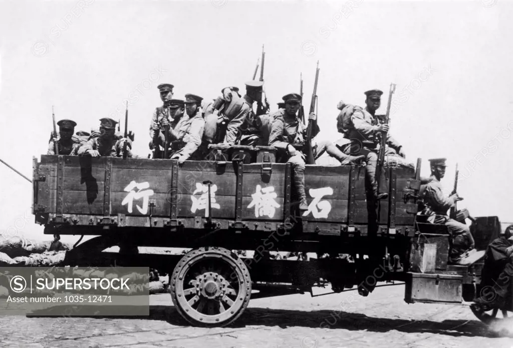 Nanking, China:  c. 1933. An army truck laden with Japanese soldiers awaits orders after the national Chinese government announced that they would not negotiate directly with Japan, Instead, the Chinese people called for a general mobilzation against Japan, and flags flew at half staff over most of China in observance of 'Humiliation Day'.