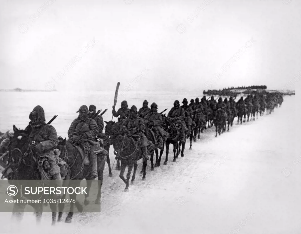 Manchuria:  c. 1935. Japanese cavalrymen of the first Brigade bundle up against the bitter cold of northern Manchuria as they advance against the Chinese insurgents.
