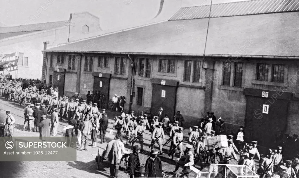 Tsing-Tao, China:  c. 1934. Japanese troops debarking at the docks of Tsing-tao to board the railroad for Tsinan, the capital of Shantung.