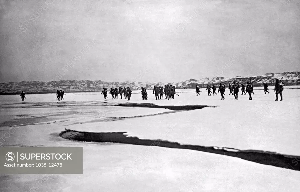 Jehol, China: c. 1933. Japanese troops pursue Chinese General Tang Yu Lin's troops across the frozen Chialaiho river in northern Jehol.