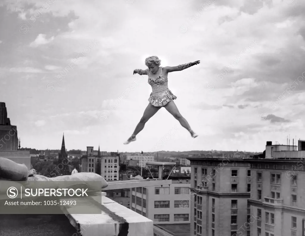 Washington, D.C.:  June 5, 1954 Betty Fox performs her acrobatic routine on a tiny platform extended from the roof of the Ambassador Hotel. She is 100 feet above the sidewalk below.