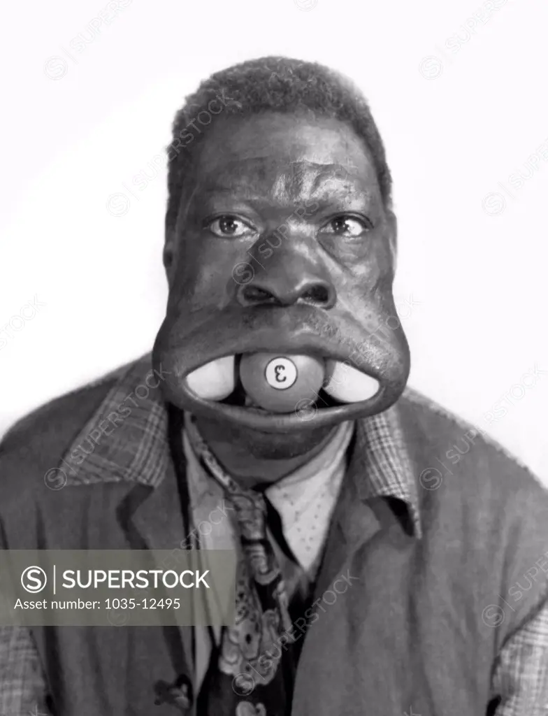 United States:  c. 1945 Three Ball Charlie, a side show performer from Nebraska who could put three billiard balls in his mouth.