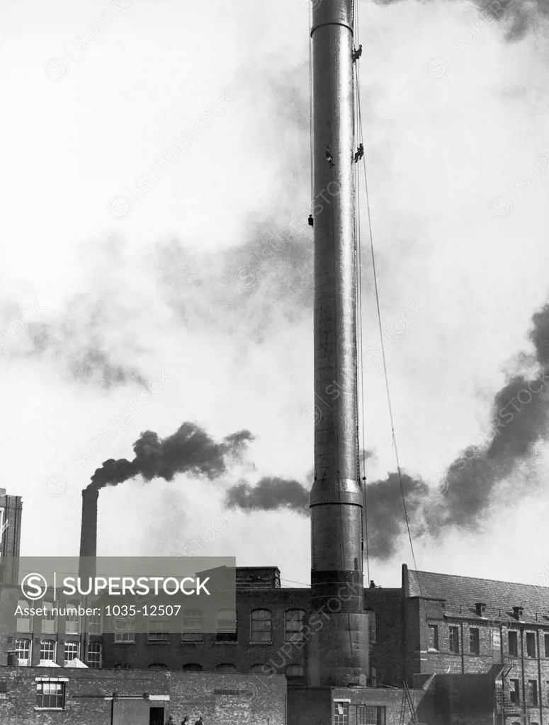 Belfast, Ireland:  c. 1923 Steeplejacks painting the Greeves' Mill chimney, the tallest in Ireland at 220 feet.