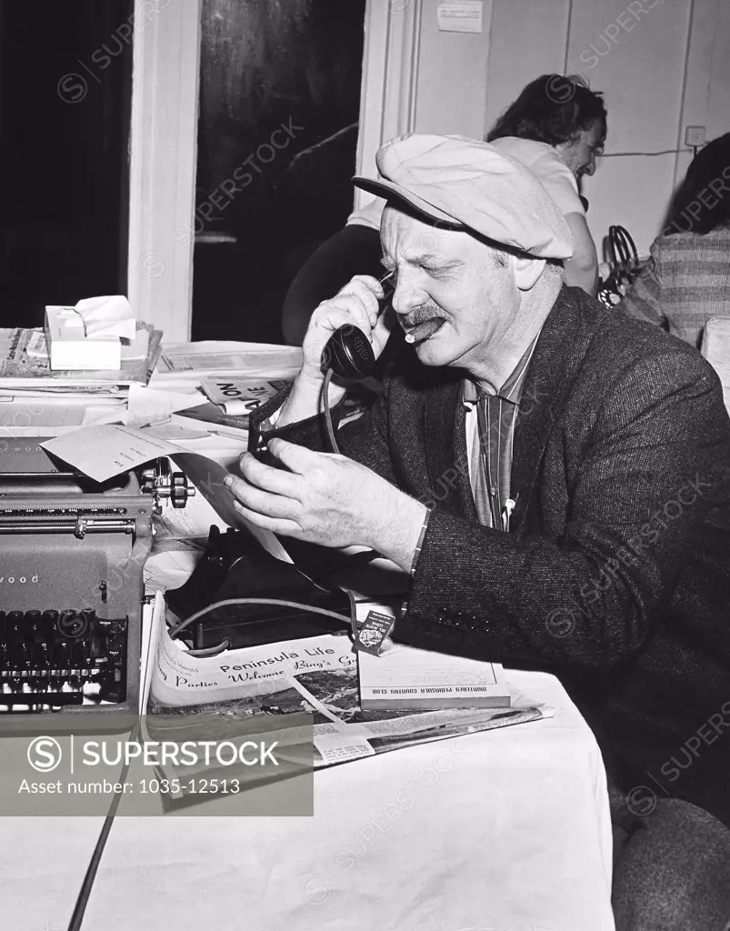 Pebble Beach, California:  c. 1958 A sports reporter at the Crosby Clambake Golf Tournament.