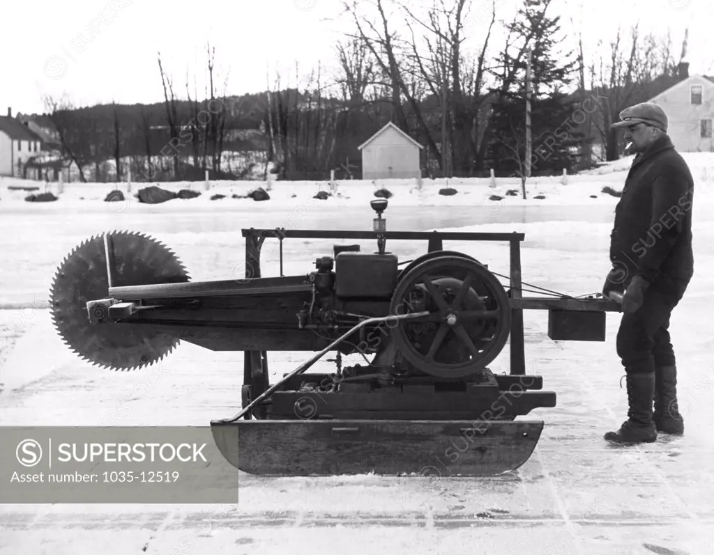 Norway, Maine:  c. 1929 A shoemaker by trade, this man created a machine to cut blocks of ice to supplement his income for his family of ten. With a circular saw and a gasoline engine mounted on runners, he is cutting over 1000 cakes of ice per day.