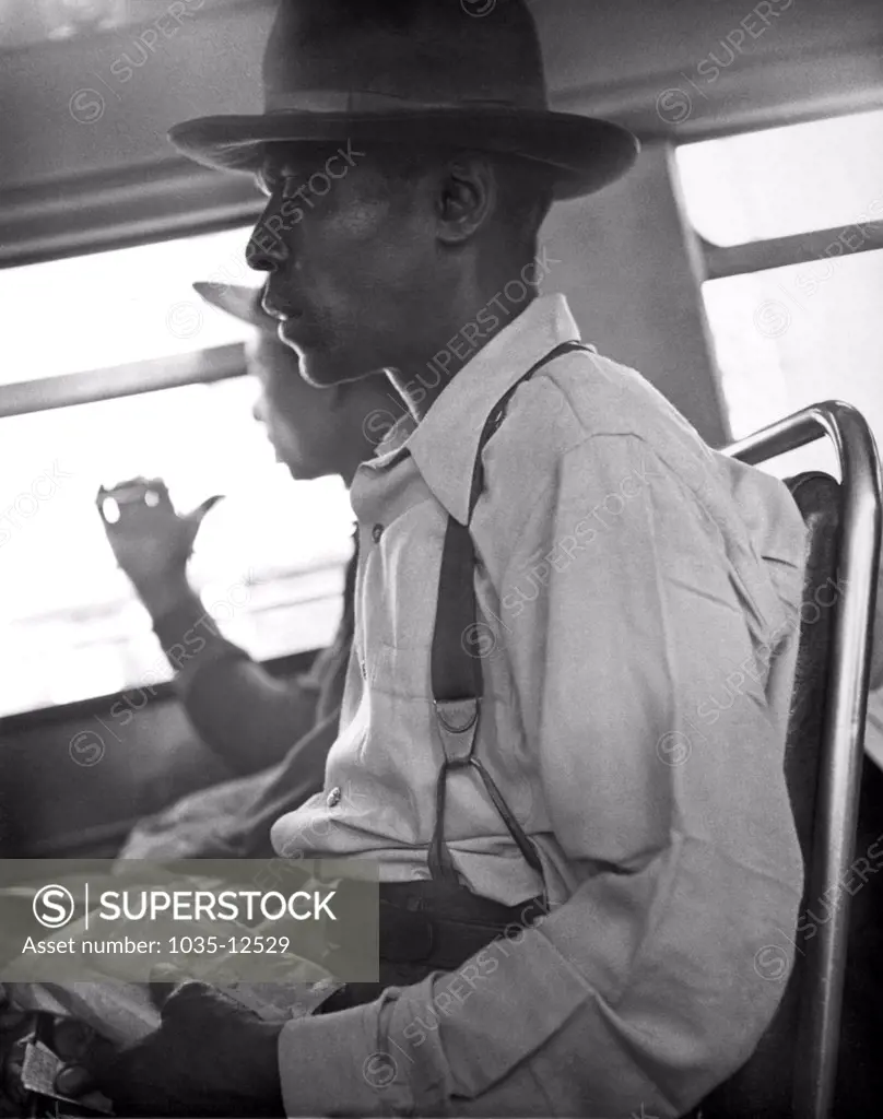 c. 1934 Two black men riding in a bus.