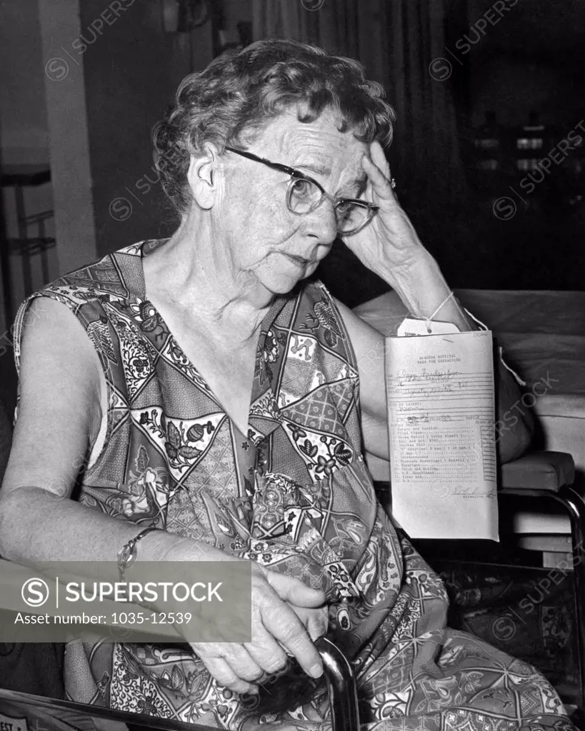 Alameda, California:  February, 1973. A weary elderly woman sits in a hospital waiting room.