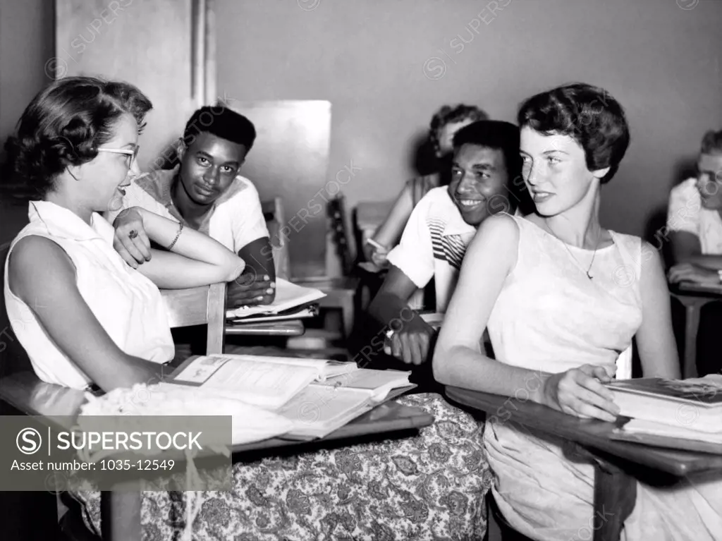 Oak Ridge, Tennessee:  September 20, 1955 Negro and white students chat while waiting for a history lesson to begin at Oak Ridge HIgh School. Previously an all-white institution, the school has been desegregated by order of the Atomic Energy Commission, which administers the affairs of the community.