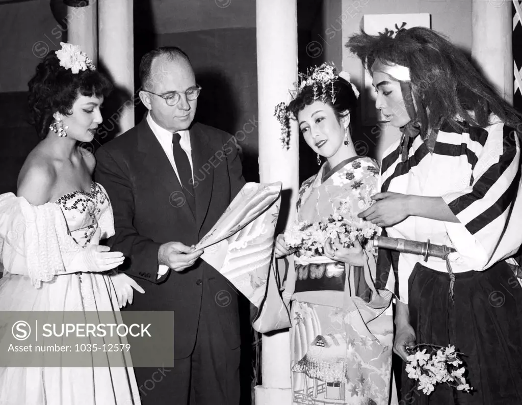 Tokyo, Japan:  February 11, 1954 Author James Michener in front of the Imperial Theater where he attended the musical, 'Comedy of Miss Butterfly'. L-R: Helen Higgins, Michener, and actors Takako Mikami and Masao Songoku.