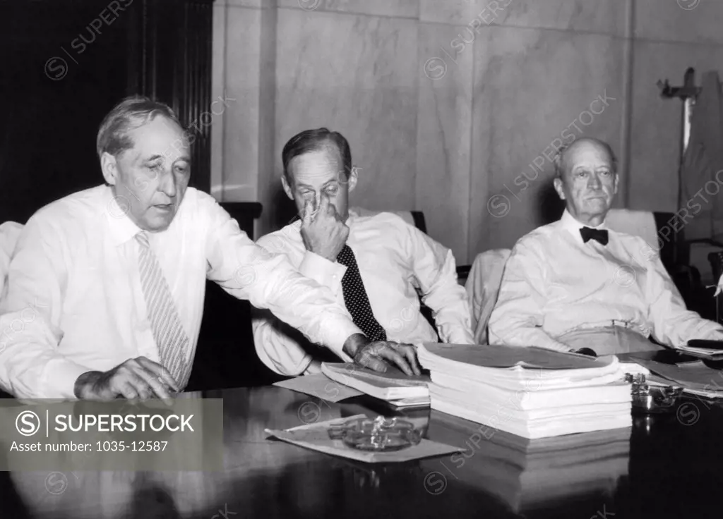 Washington, D.C.:  July 10, 1935 Senators shed their decorum and their coats today as a heat wave gripped the Capitol. L-R: Senators King of Utah, Tydings of Maryland, and Metcalf of Rhode Island.