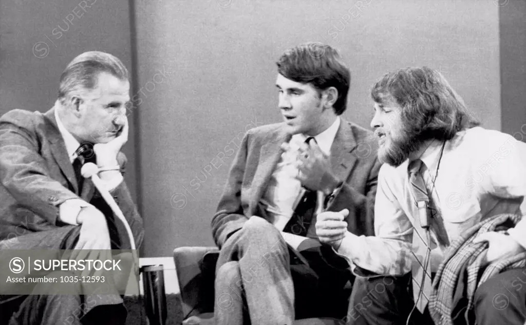 New York, New York:  September 21, 1970 Vice President Spiro T. Agnew listens as a University of Washington student Richard Silverstein (R) makes a point as Yale Law School student Gregory Craig looks on. The 90 minute debate was broadcast on the David Frost Show.
