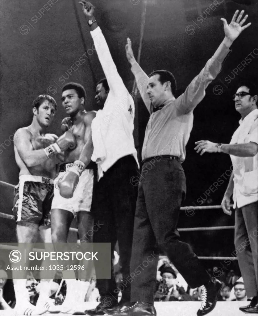 Atlanta, Georgia:  October 26, 1970. Referee Tony Perez signals the end of the fight between Muhammad Ali and Jerry Quarry. Angelo Dundee, Ali's manager, is at the right.