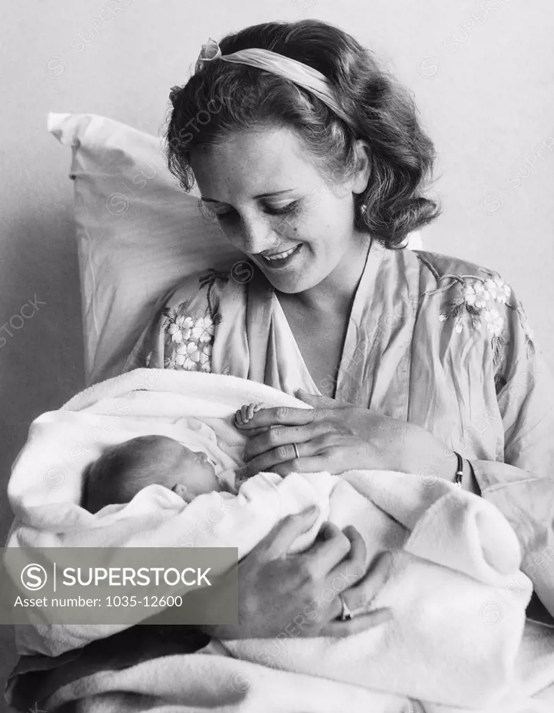 Honolulu, Hawaii:   June 15, 1932 Newly born Marylyn Hauoli Thorpe keeps a tight grip on her mother, who is well known as Mary Astor in the movies.
