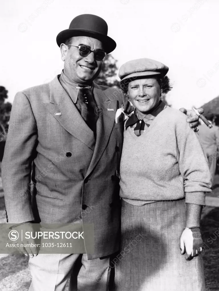 New Orleans, Louisiana:  c. 1952 Pro golfer Patty Berg meets up with New Orleans restaurateur Diamond Jim Moran at the New Orleans Women's Open golf tournament.