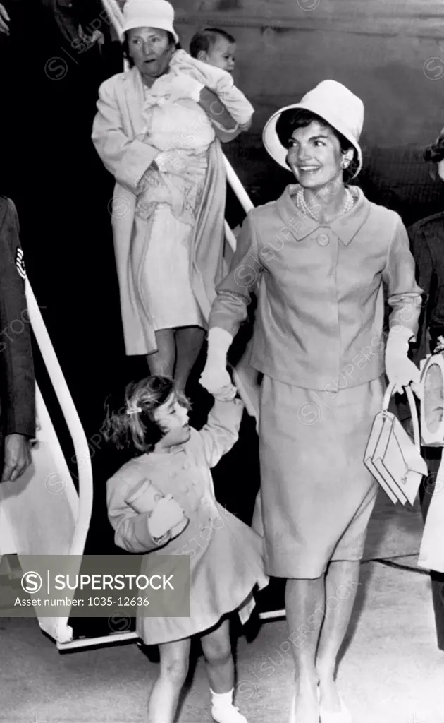 Otis Air Force Base, Massachusetts:  June 30, 1961 Jacqueline Kennedy, with daughter Caroline in hand and son John Jr. carried by their nurse, arrives to spend the long July Fourth weekend at Hyannis Port with the President.