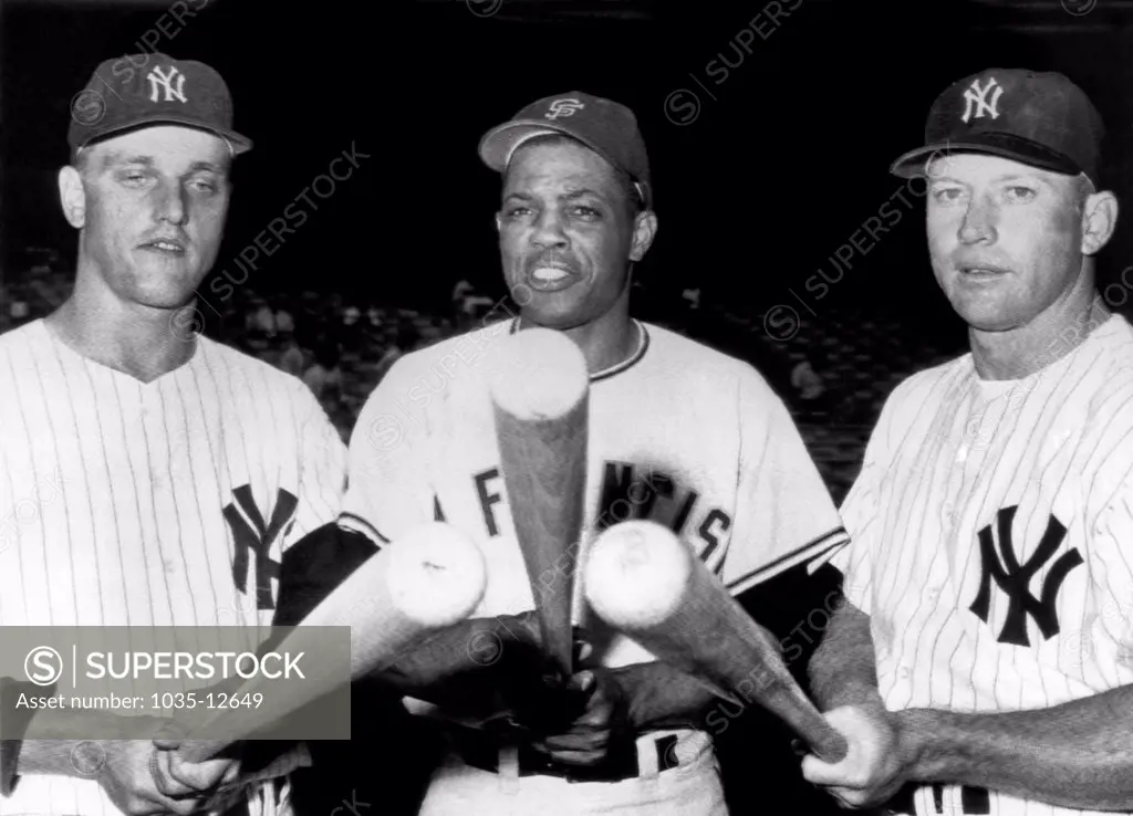 New York, New York:  July 24, 1961. Slugging outfielders before an exhibition game at Yankee Stadium. L-R: Roger Maris, Yankees, Willie Mays, Giants, and Mickey Mantle, Yankees.