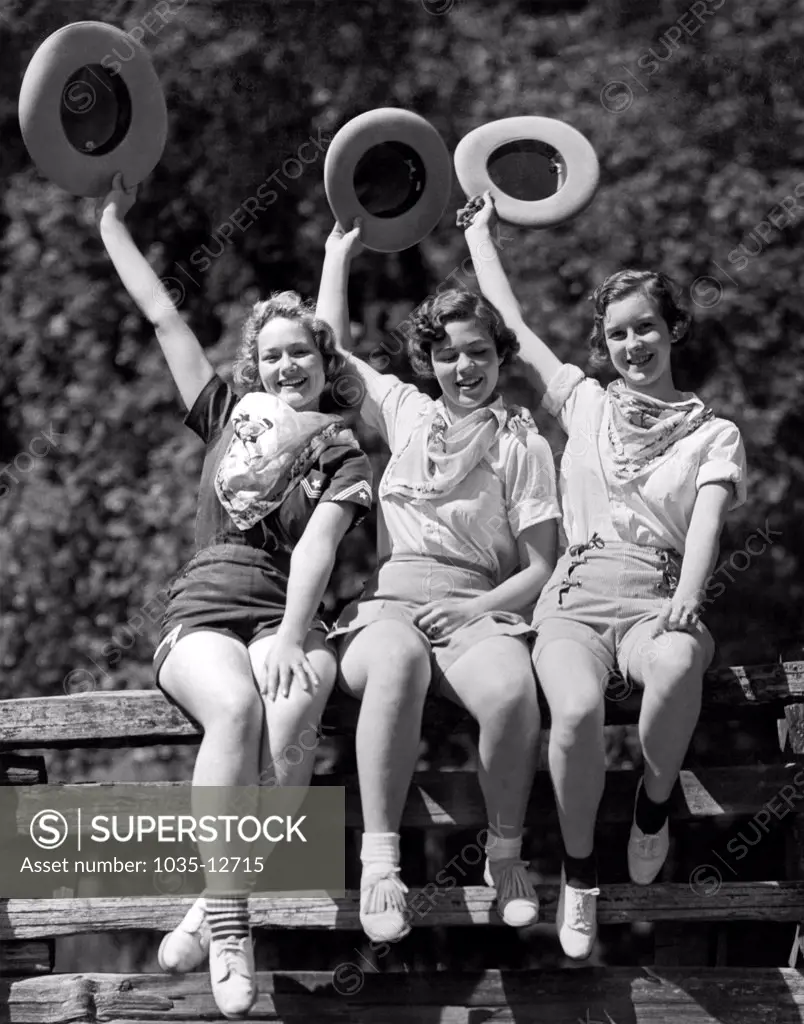 Willits, California:  1936. Three cowgirls on a corral fence are ready for the Frontier Days celebration held over the Fourth of July in Willits.