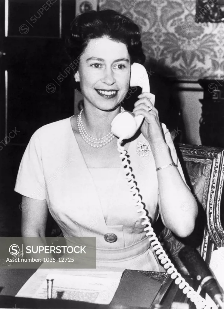 London, England:  December 19, 1961 Britain's Queen Elizabeth talks to Canadian Prime Minister John Diefenbaker as she inaugurated the Canadian Trans-Atlantic Telephone cable system by making the first call to Ottawa. It will eventually join all the Commonwealth nations.