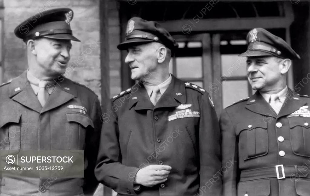 England:  April 21, 1944 Supreme Allied Commander General Dwight D. Eisenhower (L) chats with Lt. Gen. Carl D. Spaatz (C), Chief Of U.S. Strategic Air Forces in England, and Lt. Gen. James H. Doolittle (R), Commander of the Eigth U.S. Army Air Force, during his visit to a bomber station in England.