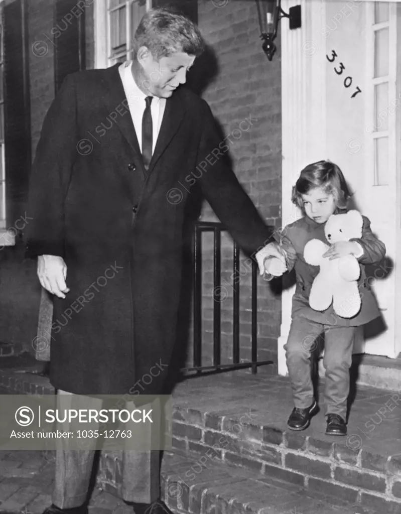 Washington, D.C.:  November 26, 1960 President-elect John F.Kennedy takes his daughter Caroline by the hand as they leave home. She will be three tomorrow.