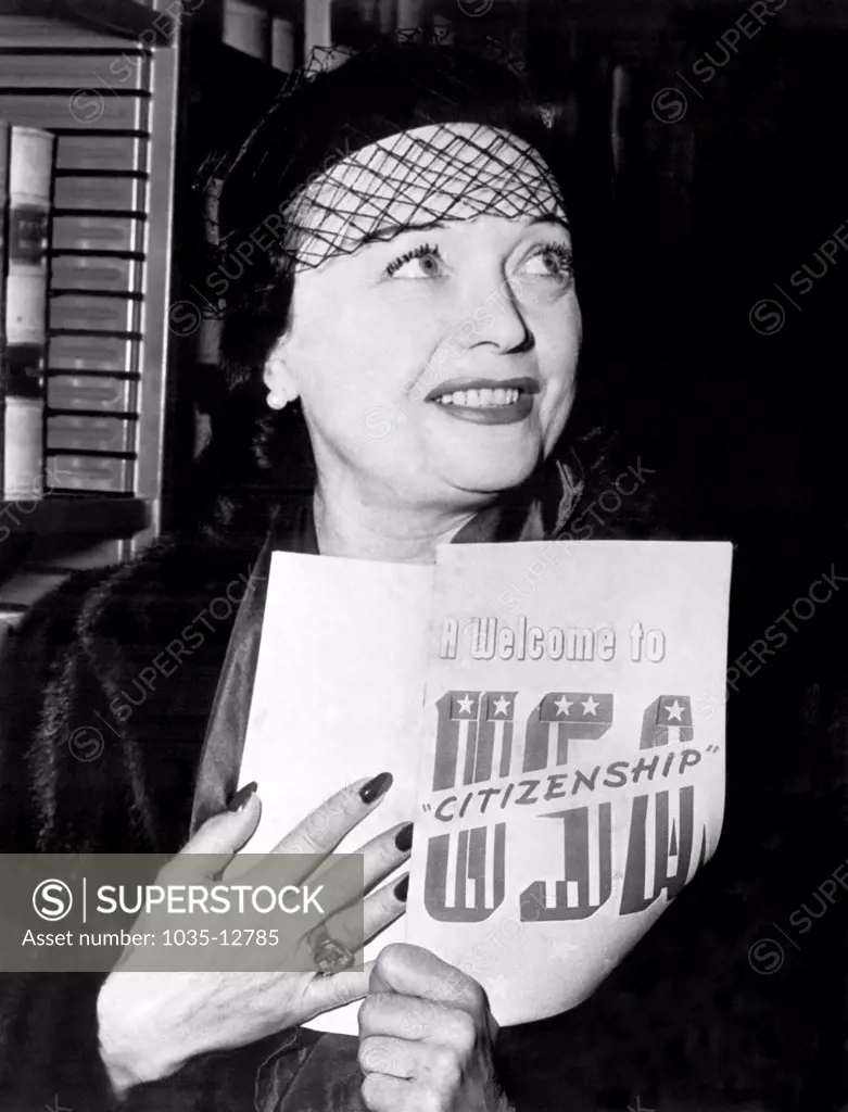 United States:  January 12, 1951 Actress Pola Negri of Poland holds her 'Welcome to USA Citizenship' pamphlet as she becomes  a U.S. citizen.