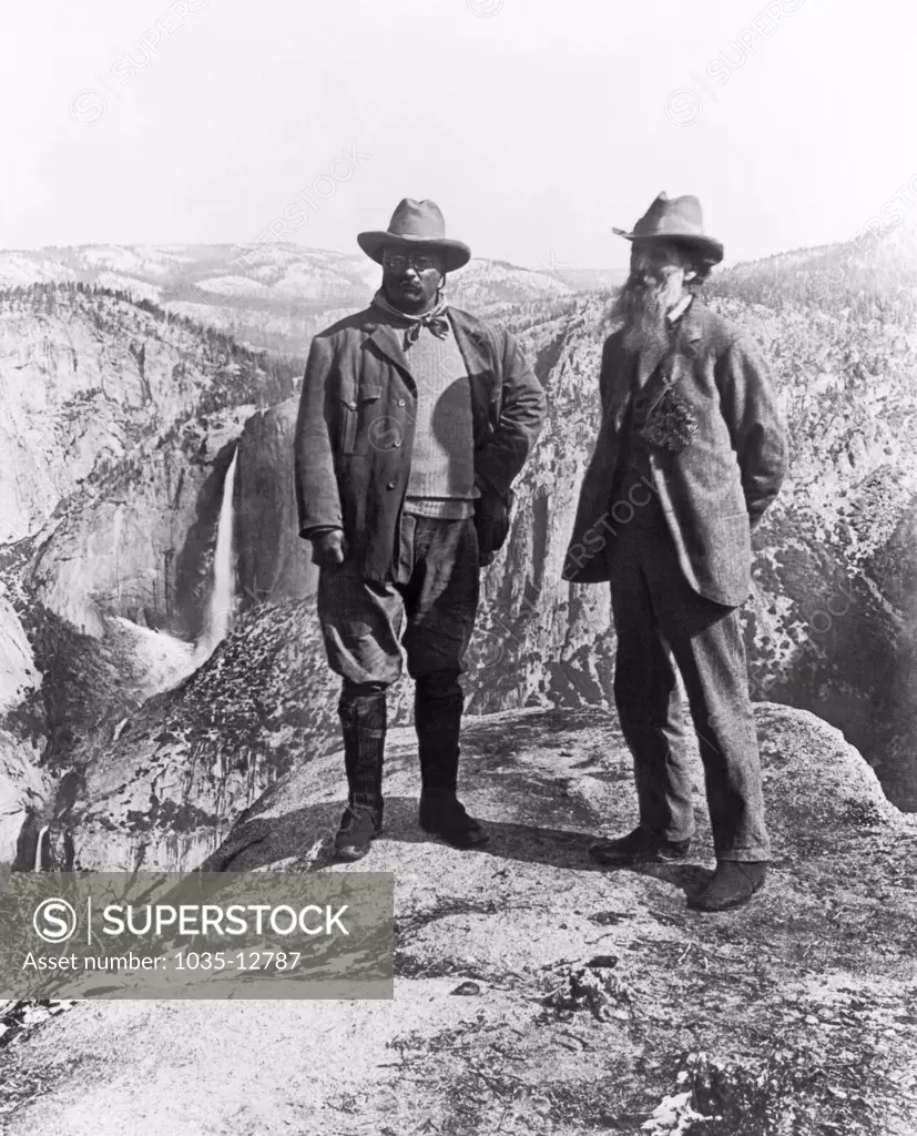 Yosemite National Park, California:  1903 Theodore Roosevelt and John Muir standing on Glacier Point overlooking the Yosemite Valley below.