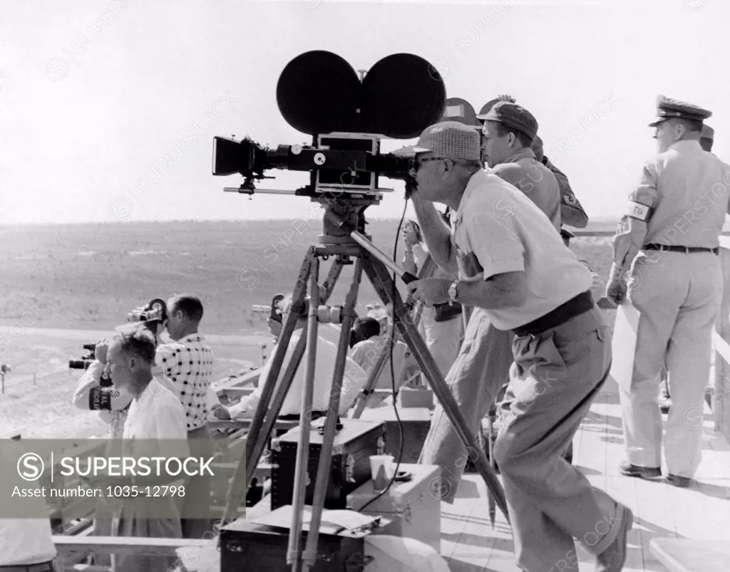 United States:   c. 1958 Photographers filming at an unidentified military event