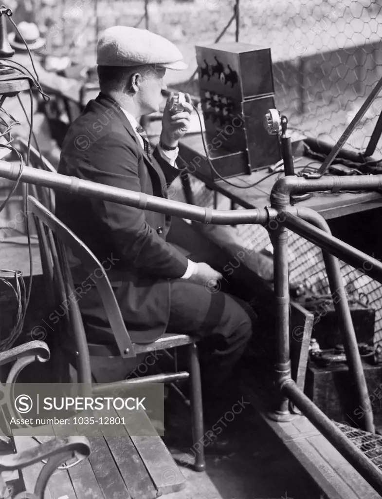 New York, New York:  October 6, 1924 An AT&T engineer tests out his company's equipment for broadcasting the third game of the 1924 World Series at the Polo Grounds in New York.