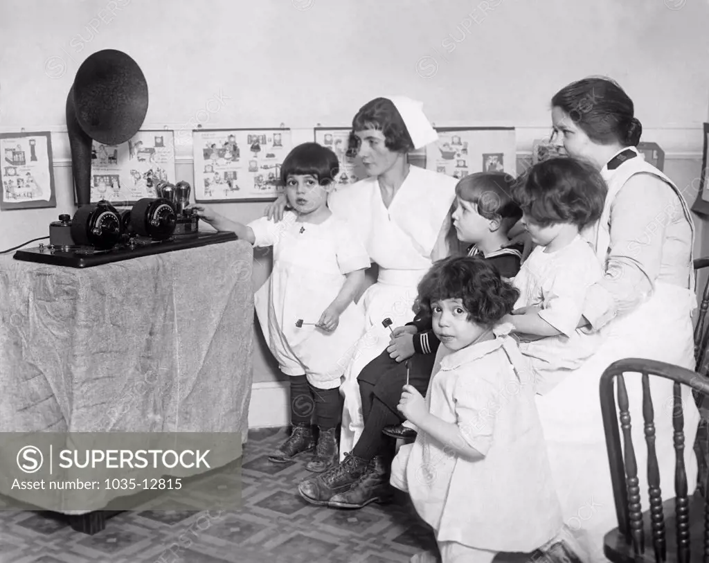 New York, New York:  February 6, 1925 Children and nurses at the Brooklyn Nursery and Infants Hospital listen to a radio that was donated to the hospital last Christmas. The facility is administered by the Salvation Army.