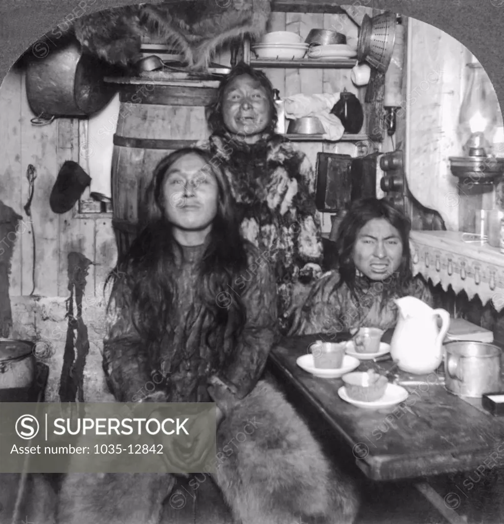 Fort Magnesia, Cape Sabine, Ellesmere Land, Canada:   c. 1900 An Eskimo family poses in its home.