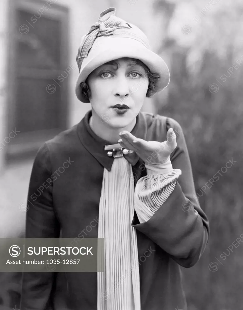 Hollywood, California:    c.  1920 Silent film actress Anna Q. Nillson blows a kiss to the viewer