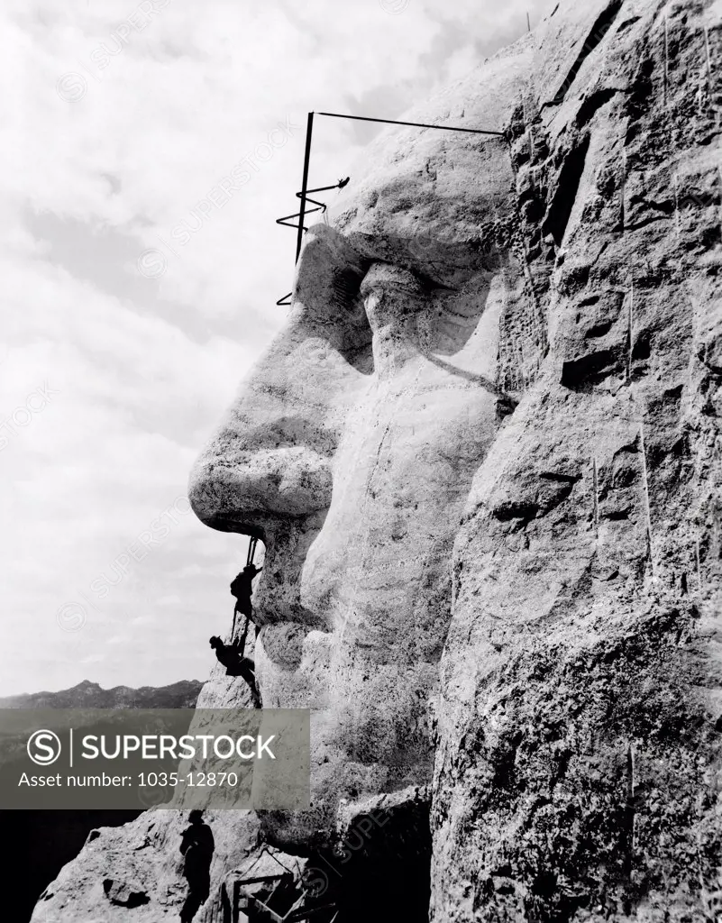 Mt. Rushmore, South Dakota: c. 1932. Workmen working on the face of George Washington on Mt. Rushmore.