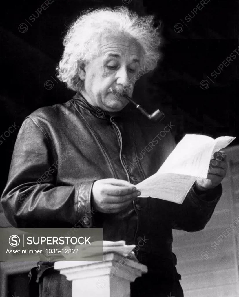 United States:   May, 1938 Theoretical physicist Albert Einstein reading a letter