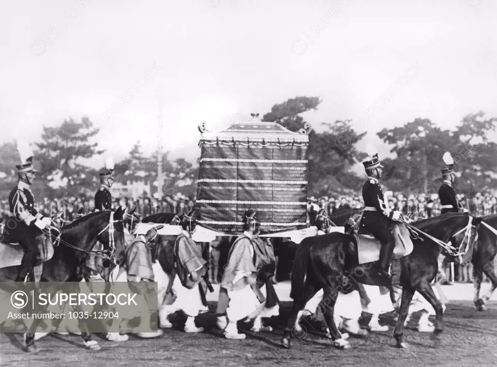 Kyoto, Japan:  November, 1928 The Kashikodokoro, Ark of the Sacred Mirror, dedicated to the soul of the Sun Goddess, passing in the coronation ceremonies of Emperor Hirohito. The 'Yase Boys', bearers of the Ark from time immemorial, carry it on their shoulders.