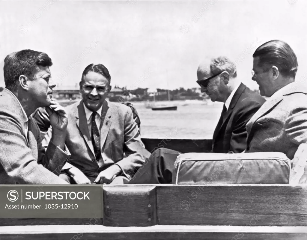 Hyannis Port, Massachusetts: July 8, 1961 President Kennedy and his advisors aboard the yacht Marlin discussing the Berlin problem. L-R are the President, General Maxwell Taylor, Secretary of State Dean Rusk, and Secretary of Defense Robert McNamara.