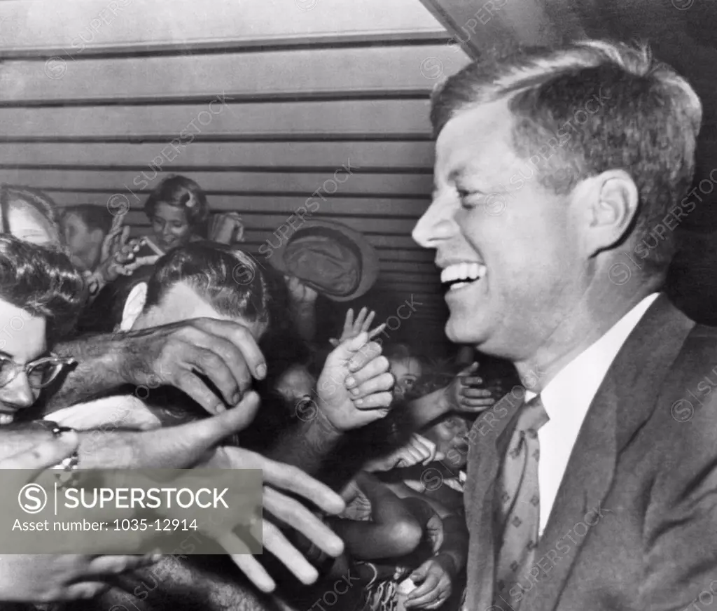 West Palm Beach, Florida:  November 11, 1960 President-elect John F. Kennedy wears a big smile as hundreds of well-wishers greet him at the West Palm Beach Airport.