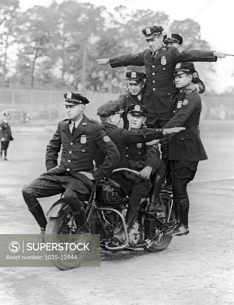 New York, New York:  c. 1937 Members of the New York City Police motorcycle division practice their routines for the upcoming benefit show at Madison Square Garden for the Police Activities League.