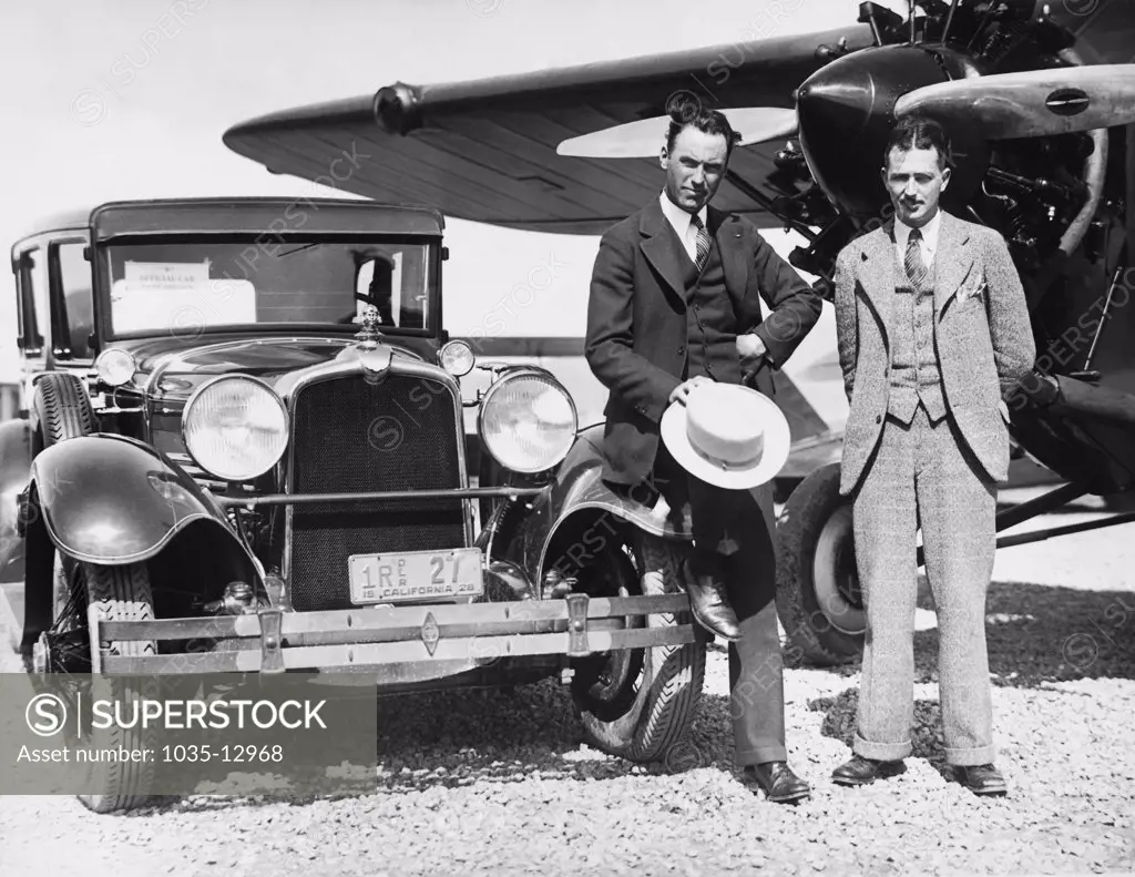 California:  1928 Howard Hughes and stunt flyer Roscoe Turner at an airport in California. Hughes is driving the official car of the Pacific Aero Club.