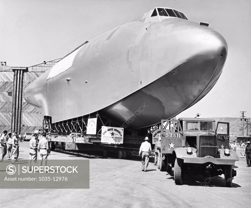 Culver City, California:  June 16, 1946 The 220 foot long hull of Howard Hughes' flying boat emerges from its hangar to begin the 28 mile trip to Long Beach where it will be assembled with its 320 foot wing.