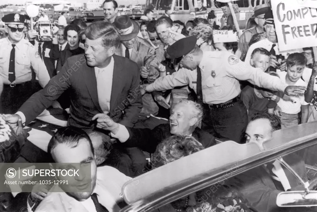 Memphis, Tennessee:  1960 Senator Kennedy is greeted in Memphis by supporters on his arrival at the airport. Senator Albert Gore is seated beside him and Memphis mayor Henry Loeb is at lower left.