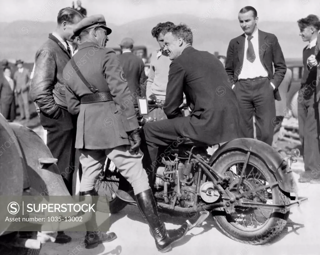 Monterey, California:  March 11, 1930 Charles Lindbergh tries out a motorcycle borrowed from State Traffic Patrolman Leo Ramsey during a trip to Del Monte.