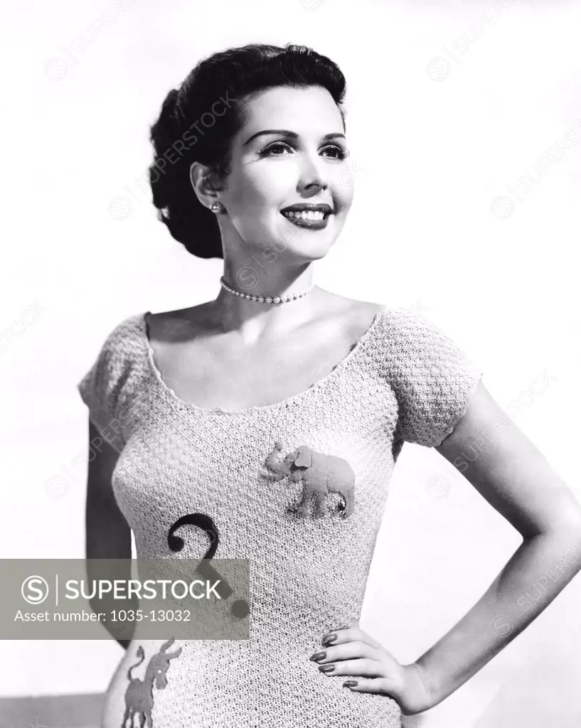Hollywood, California: July 9, 1952 Actress and dancer Ann Miller displays her dilemma with the Democrats and Republicans this election year.