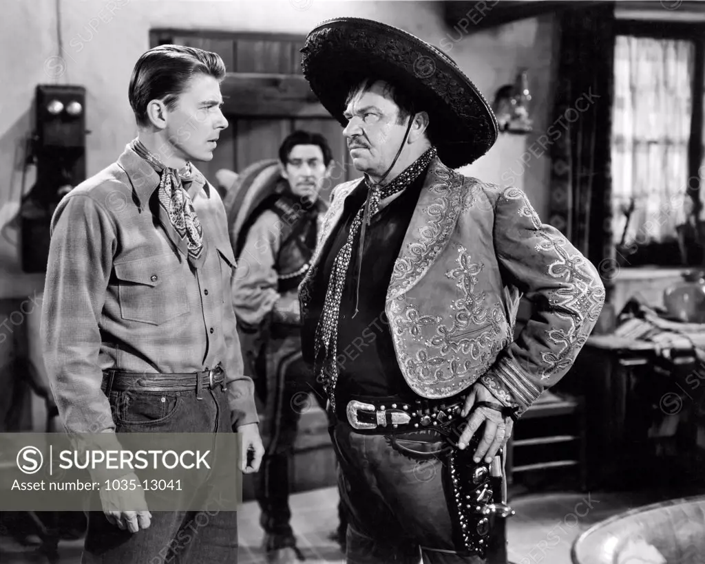 Hollywood, California:  1941 Actor Ronald Reagan defies bad guy Wallace Beery in a dramatic scene in the film, 'The Bad Men'.