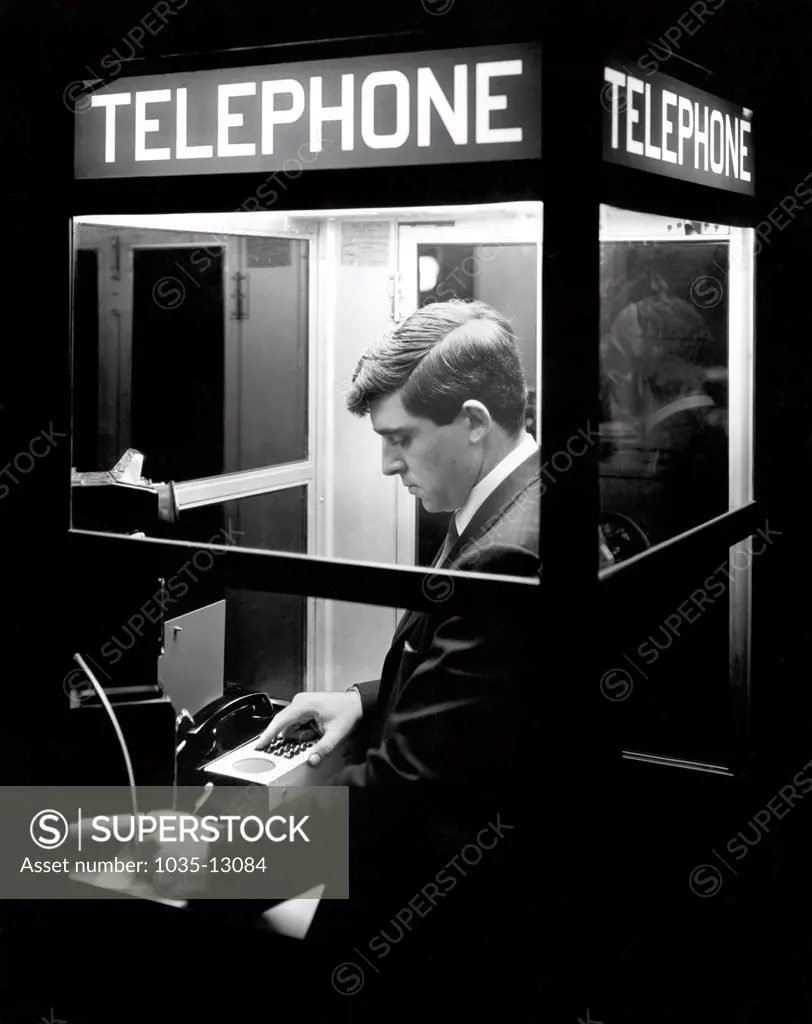 Boston, Massachusetts:  c. 1968 This man now has 24 hour access, even from a telephone booth, to a remote computer with the Honeywell Electronic Data Processing Division's COM-PACT portable computer terminal.